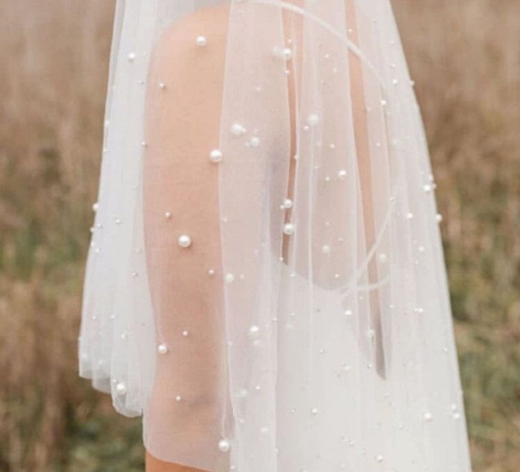 Detachable straps. Beads and pearls dotted throughout on tulle