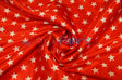 Red star-print satin twisted into a swirl with glossy flowing folds