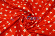 Red star-print satin twisted into a swirl with glossy flowing folds