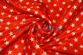 Red star-print satin twisted into a swirl with glossy flowing folds