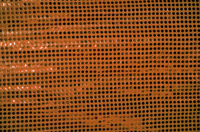 Close-up of orange confetti dot sequins fabric by mytextilefabric